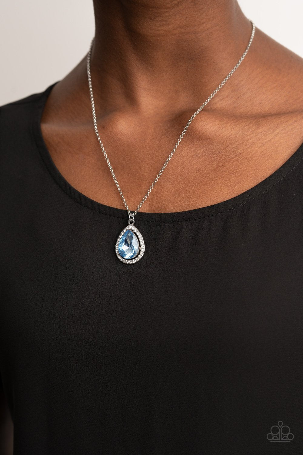 &lt;p&gt;An oversized Cerulean rhinestone teardrop is pressed into the center of a silver frame bordered in white rhinestones, creating a glamorous pendant below the collar. Features an adjustable clasp closure. &lt;/p&gt;
 

 &lt;p&gt;&lt;i&gt; Sold as one individual necklace. Includes one pair of matching earrings.
 &lt;/i&gt;&lt;/p&gt;
 

&lt;h5&gt;Paparazzi Accessories • $5 Jewelry&lt;/h5&gt;