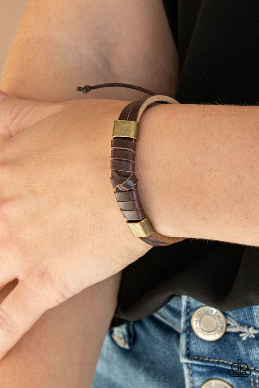&lt;p&gt;Infused with two brass fittings, a brown leather lace is knotted in place around two brown leather cords around the wrist for an edgy urban look. Features an adjustable sliding knot closure. &lt;/p&gt;
 

 &lt;p&gt;&lt;i&gt; Sold as one individual bracelet.&lt;/i&gt;&lt;/p&gt;
 

 

&lt;h5&gt;Paparazzi Accessories • $5 Jewelry&lt;/h5&gt;