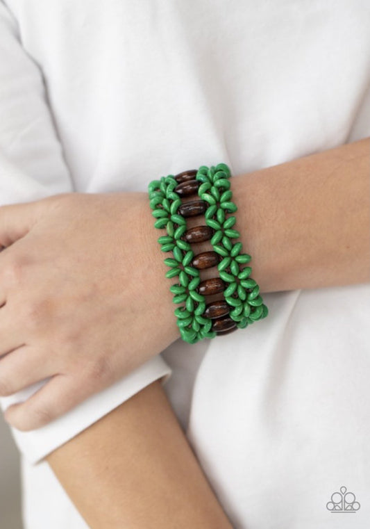 &lt;span data-mce-fragment=\&quot;1\&quot;&gt;Green wooden discs and brown wooden beads are threaded along braided stretchy bands around the wrist, creating a colorful tropical display.&lt;/span&gt;