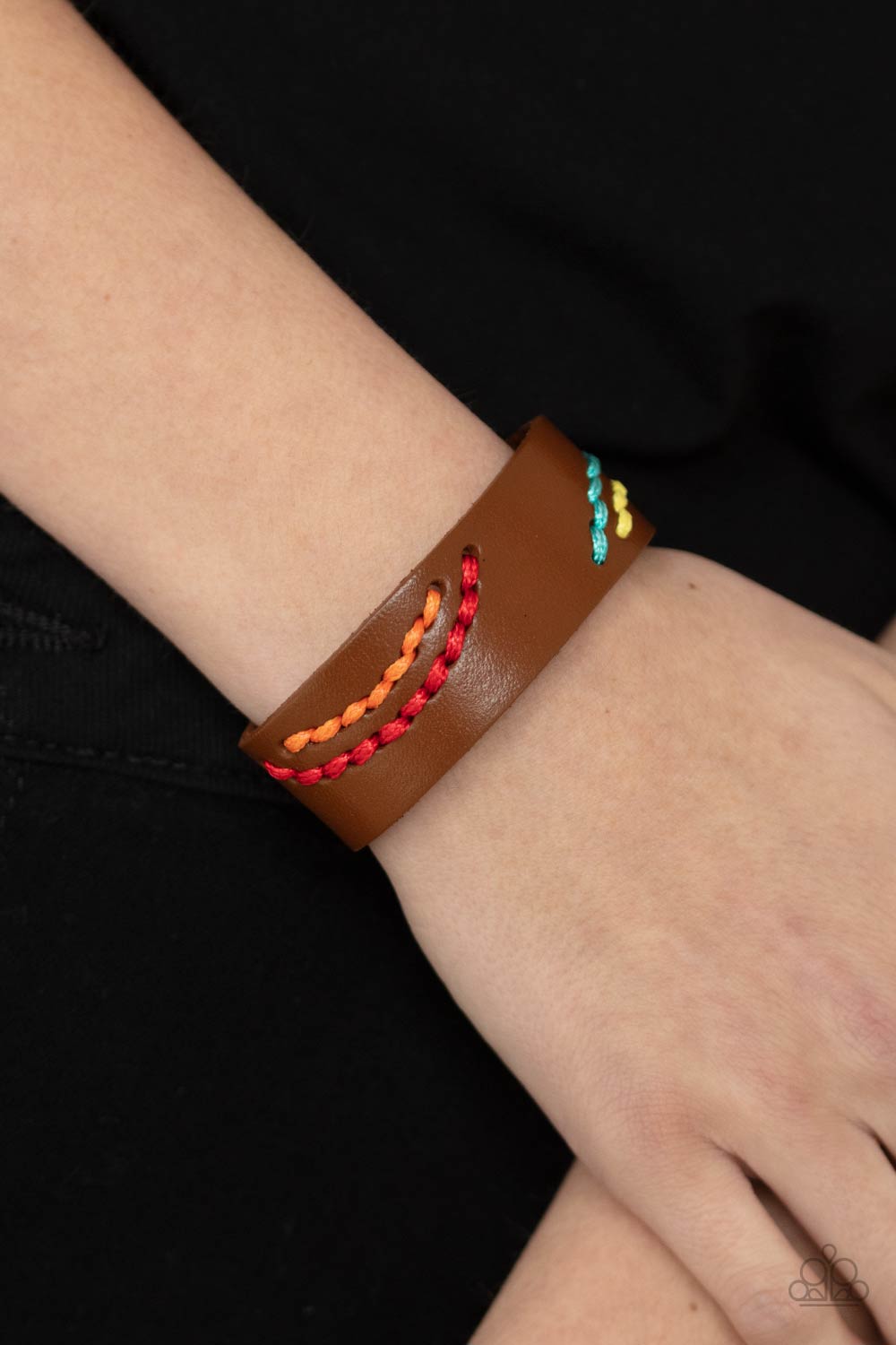 &lt;p&gt;Multicolored cording is stitched across the front of a brown leather band, creating curved patterns. Features an adjustable snap closure. &lt;/p&gt;

&lt;p&gt;&lt;i&gt; Sold as one individual bracelet.&lt;/i&gt;&lt;/p&gt;


&lt;img src=\&quot;https://d9b54x484lq62.cloudfront.net/paparazzi/shopping/images/517_tag150x115_1.png\&quot; alt=\&quot;New Kit\&quot; align=\&quot;middle\&quot; height=\&quot;50\&quot; width=\&quot;50\&quot;&gt;