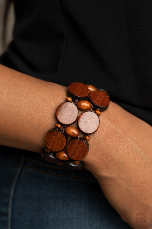 &amp;lt;P&amp;gt;Earthy wooden discs and beads are threaded along braided stretchy bands around the wrist, creating a summery display. &amp;lt;/P&amp;gt;

&amp;lt;P&amp;gt;&amp;lt;I&amp;gt; Sold as one individual bracelet.&amp;lt;/I&amp;gt;&amp;lt;/p&amp;gt;


&amp;lt;img src=\&quot;https://d9b54x484lq62.cloudfront.net/paparazzi/shopping/images/517_tag150x115_1.png\&quot; alt=\&quot;New Kit\&quot; align=\&quot;middle\&quot; height=\&quot;50\&quot; width=\&quot;50\&quot;/&amp;gt;