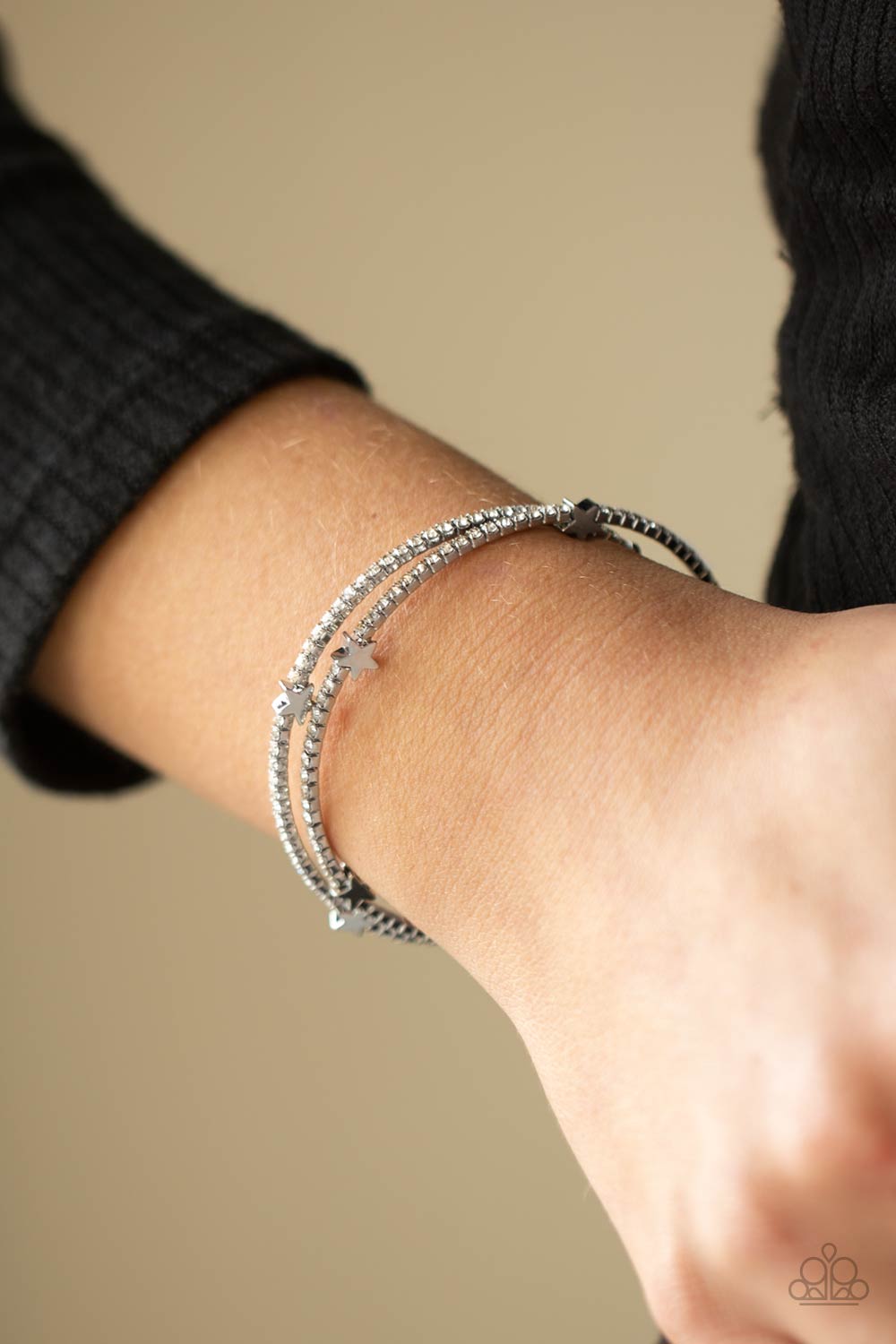 &lt;P&gt;Dotted with dainty silver star charms, a bendable row of glittery white rhinestones spirals around the wrist, creating a sparkly infinity wrap bracelet. &lt;/P&gt;

&lt;P&gt;&lt;I&gt; Sold as one individual bracelet. &lt;/I&gt;&lt;/p&gt;


&lt;img src=\&quot;https://d9b54x484lq62.cloudfront.net/paparazzi/shopping/images/517_tag150x115_1.png\&quot; alt=\&quot;New Kit\&quot; align=\&quot;middle\&quot; height=\&quot;50\&quot; width=\&quot;50\&quot;/&gt;
