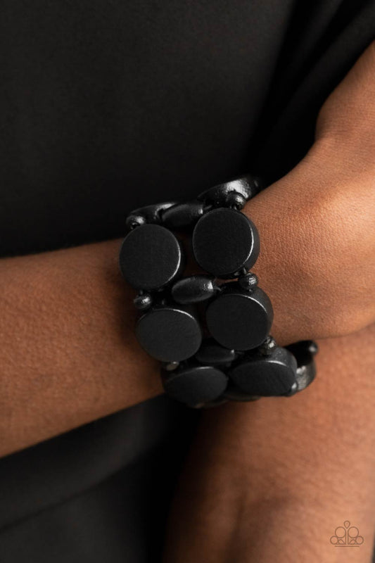 &lt;p&gt;Earthy black wooden discs and beads are threaded along braided stretchy bands around the wrist, creating a summery display.
  &lt;/p&gt;
 

 &lt;p&gt;&lt;i&gt; Sold as one individual bracelet.&lt;/i&gt;&lt;/p&gt;
 

 

&lt;h5&gt;Paparazzi Accessories • $5 Jewelry&lt;/h5&gt;