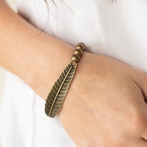 &lt;p&gt; Infused with a lifelike brass feather frame, a row of rustic brass beads are threaded along stretchy bands around the wrist for a seasonal fashion.&lt;/p&gt;

&lt;p&gt;&lt;i&gt; Sold as one individual bracelet.&lt;/i&gt;&lt;/p&gt;


&lt;br&gt;