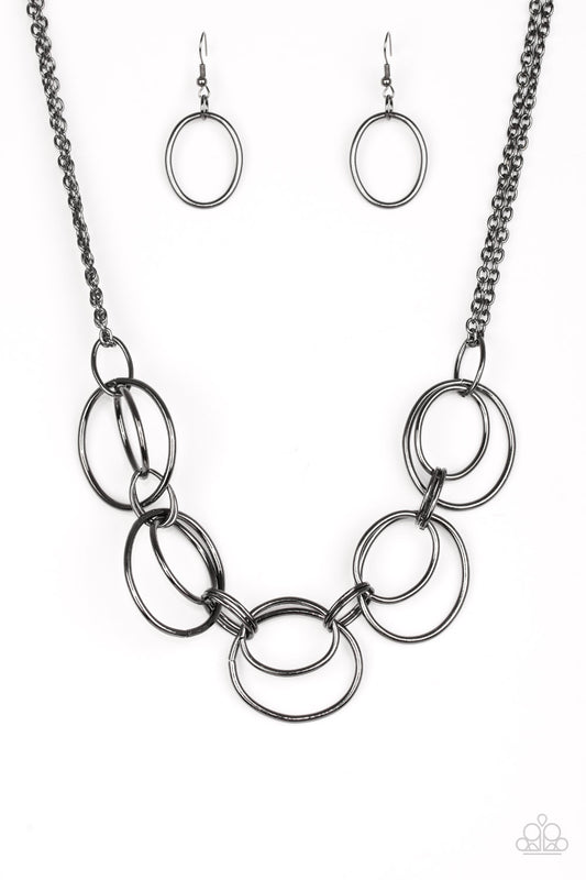 &lt;P&gt;Doubled gunmetal hoops link below the collar for a bold industrial look. Features an adjustable clasp closure.&lt;/p&gt;

&lt;P&gt;&lt;i&gt; Sold as one individual necklace.  Includes one pair of matching earrings.
&lt;/i&gt;&lt;/p&gt;

&lt;img src=\&quot;https://d9b54x484lq62.cloudfront.net/paparazzi/shopping/images/517_tag150x115_1.png\&quot; alt=\&quot;New Kit\&quot; align=\&quot;middle\&quot; height=\&quot;50\&quot; width=\&quot;50\&quot;/&gt;