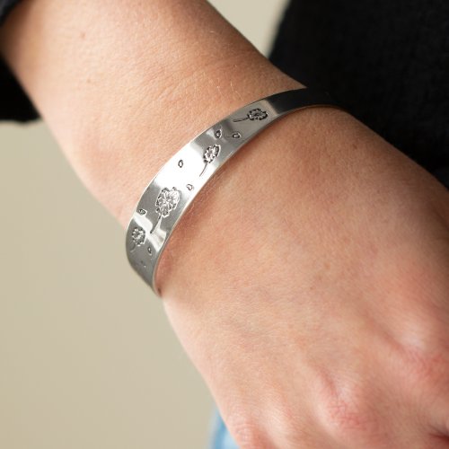 &lt;p&gt;Flowery dandelion-like patterns are stamped across the front of an uneven silver bangle, creating a stackable seasonal display around the wrist. &lt;/p&gt;

&lt;p&gt;&lt;i&gt; Sold as one individual bracelet. &lt;/i&gt;&lt;/p&gt;


&lt;img src=\&quot;https://d9b54x484lq62.cloudfront.net/paparazzi/shopping/images/517_tag150x115_1.png\&quot; alt=\&quot;New Kit\&quot; align=\&quot;middle\&quot; height=\&quot;50\&quot; width=\&quot;50\&quot;&gt;