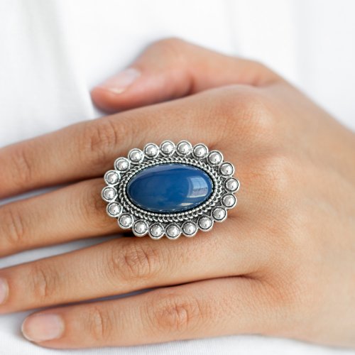 &lt;p&gt; Painted in the confident shade of Evening Blue, an oversized blue bead is pressed into the center of a textured silver frame radiating in a ring of shimmery silver studs for a whimsical pop of color. Features a stretchy band for a flexible fit.&lt;/p&gt;  

&lt;p&gt; &lt;i&gt;  Sold as one individual ring.
&lt;/i&gt;&lt;/p&gt;


&lt;imgsrc alt=\&quot;New Kit\&quot; align=\&quot;middle\&quot; height=\&quot;50\&quot; width=\&quot;50\&quot;&gt;&lt;/imgsrc&gt;