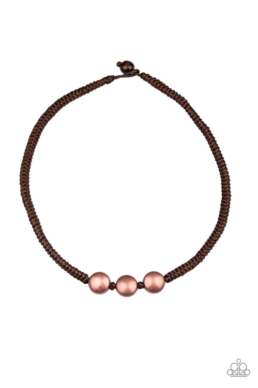 &lt;P&gt;Three antiqued copper beads are knotted in place along a brown braided cord below the collar for an urban look. Features a button loop closure.&lt;/P&gt;  

&lt;P&gt; &lt;I&gt; Sold as one individual necklace.&lt;/I&gt;  &lt;/P&gt;


&lt;img src=\&quot;https://d9b54x484lq62.cloudfront.net/paparazzi/shopping/images/517_tag150x115_1.png\&quot; alt=\&quot;New Kit\&quot; align=\&quot;middle\&quot; height=\&quot;50\&quot; width=\&quot;50\&quot;/&gt;