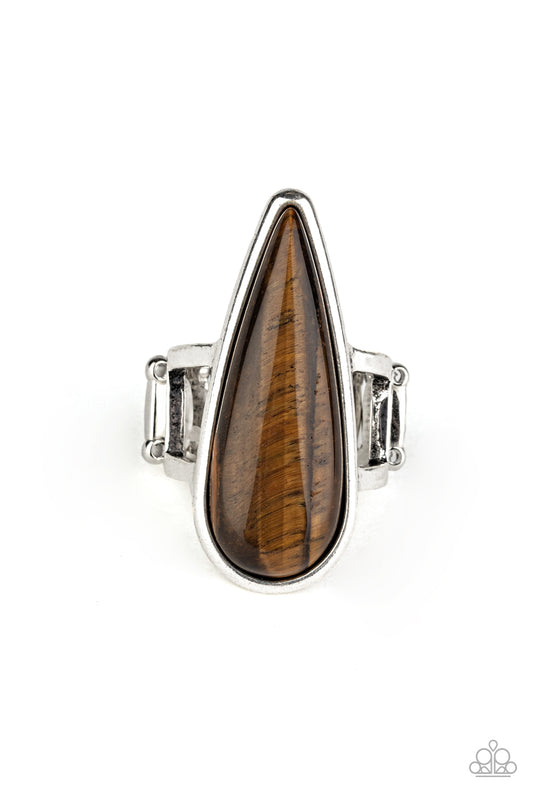 &lt;P&gt;An elongated Tiger\&#039;s Eye stone teardrop is pressed into a sleek silver frame atop the finger, creating a mystical centerpiece. Features a dainty stretchy band for a flexible fit. &lt;/P&gt;  

&lt;P&gt; &lt;I&gt;  Sold as one individual ring.
&lt;/I&gt;&lt;/P&gt;

&lt;img src=\&quot;https://d9b54x484lq62.cloudfront.net/paparazzi/shopping/images/517_tag150x115_1.png\&quot; alt=\&quot;New Kit\&quot; align=\&quot;middle\&quot; height=\&quot;50\&quot; width=\&quot;50\&quot;/&gt;