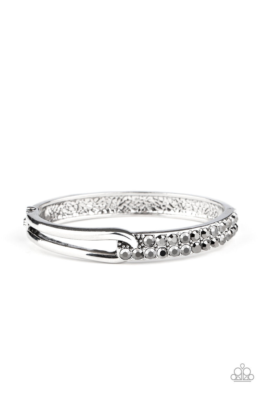 &lt;P&gt;An airy silver fitting links with a silver band encrusted in two rows of glittery hematite rhinestones across the wrist, creating an edgy bangle-like cuff. Features a hinged closure.
 &lt;/P&gt;

&lt;P&gt;&lt;I&gt; Sold as one individual bracelet.&lt;/I&gt;&lt;/p&gt;


&lt;img src=\&quot;https://d9b54x484lq62.cloudfront.net/paparazzi/shopping/images/517_tag150x115_1.png\&quot; alt=\&quot;New Kit\&quot; align=\&quot;middle\&quot; height=\&quot;50\&quot; width=\&quot;50\&quot;/&gt;