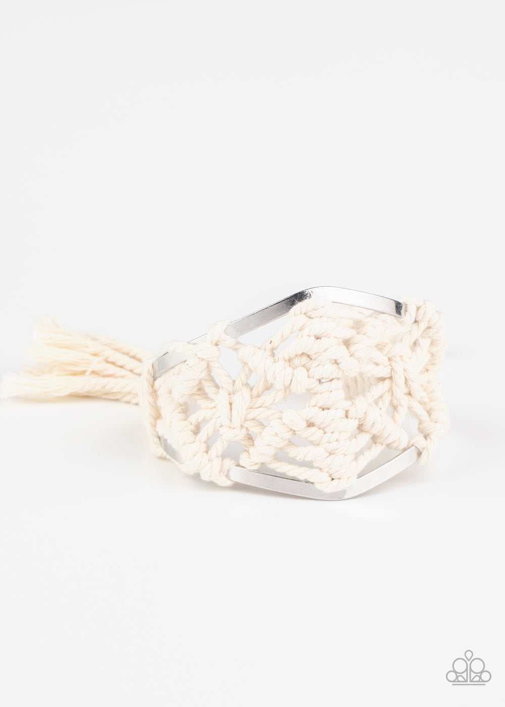 &lt;P&gt;White cording decoratively knots and weaves around an airy silver cuff for a macramé inspired look. Knotted around the ends, white tassels flair out from bottoms of the cuff for a wanderlust finish.
&lt;/P&gt;  

&lt;P&gt; &lt;I&gt;Sold as one individual.&lt;/I&gt;  &lt;/P&gt;


&lt;img src=\&quot;https://d9b54x484lq62.cloudfront.net/paparazzi/shopping/images/517_tag150x115_1.png\&quot; alt=\&quot;New Kit\&quot; align=\&quot;middle\&quot; height=\&quot;50\&quot; width=\&quot;50\&quot;/&gt;