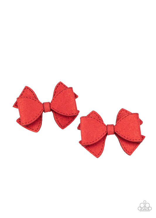 &lt;P&gt;Dusted in red glitter, two red suede ribbons delicately knot into a pair of colorful hair bows. Each bow features a standard hair clip on the back.&lt;/P&gt;

&lt;P&gt;&lt;I&gt;Sold as one pair of hair clips. &lt;/I&gt;&lt;/P&gt;


&lt;img src=\&quot;https://d9b54x484lq62.cloudfront.net/paparazzi/shopping/images/517_tag150x115_1.png\&quot; alt=\&quot;New Kit\&quot; align=\&quot;middle\&quot; height=\&quot;50\&quot; width=\&quot;50\&quot;/&gt;