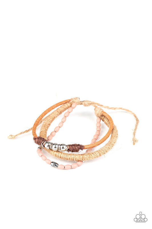 &lt;P&gt;Infused with wooden Rose Tan beads and mismatched silver accents, earthy strands of twine and suede cording layer across the wrist for a seasonal flair. Features an adjustable sliding knot closure.&lt;/P&gt;  

&lt;P&gt; &lt;I&gt;Sold as one individual bracelet.&lt;/I&gt;  &lt;/P&gt;


&lt;img src=\&quot;https://d9b54x484lq62.cloudfront.net/paparazzi/shopping/images/517_tag150x115_1.png\&quot; alt=\&quot;New Kit\&quot; align=\&quot;middle\&quot; height=\&quot;50\&quot; width=\&quot;50\&quot;/&gt;