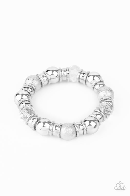 &lt;P&gt;A glittery compilation of mismatched silver beads, silver rings, and sparkly white crystal-like beads are threaded along a stretchy band around the wrist for a glamorous glow.  &lt;/P&gt;

&lt;P&gt;&lt;I&gt; Sold as one individual bracelet.&lt;/I&gt;&lt;/p&gt;


&lt;img src=\&quot;https://d9b54x484lq62.cloudfront.net/paparazzi/shopping/images/517_tag150x115_1.png\&quot; alt=\&quot;New Kit\&quot; align=\&quot;middle\&quot; height=\&quot;50\&quot; width=\&quot;50\&quot;/&gt;