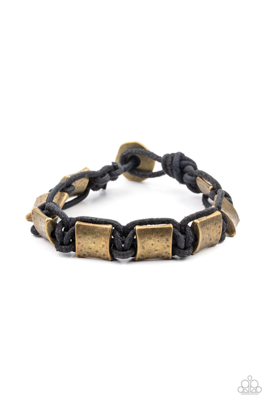 &lt;P&gt;Featuring a hammered finish, a collection of rustic brass accents are knotted in place with black cording around the wrist for a rugged look. Features a button loop closure. &lt;/P&gt;

&lt;P&gt;&lt;I&gt; Sold as one individual bracelet.&lt;/I&gt;&lt;/p&gt;


&lt;img src=\&quot;https://d9b54x484lq62.cloudfront.net/paparazzi/shopping/images/517_tag150x115_1.png\&quot; alt=\&quot;New Kit\&quot; align=\&quot;middle\&quot; height=\&quot;50\&quot; width=\&quot;50\&quot;/&gt;