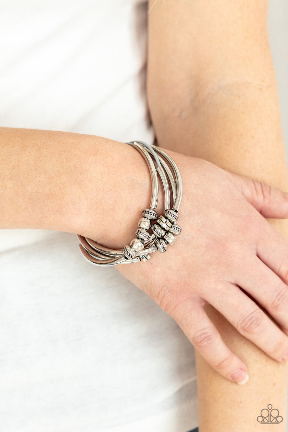 &lt;p&gt;Multiple strands of Ultimate Gray cord are fitted with long, curved cylinders that meet in the middle. The sliding bars are separated by small antiqued silver loops that mimic pipe fittings, making this a perfect addition to any industrial look. Features an adjustable clasp closure.
&lt;/p&gt;  

&lt;p&gt; &lt;i&gt;Sold as one individual bracelet.&lt;/i&gt;  &lt;/p&gt;


