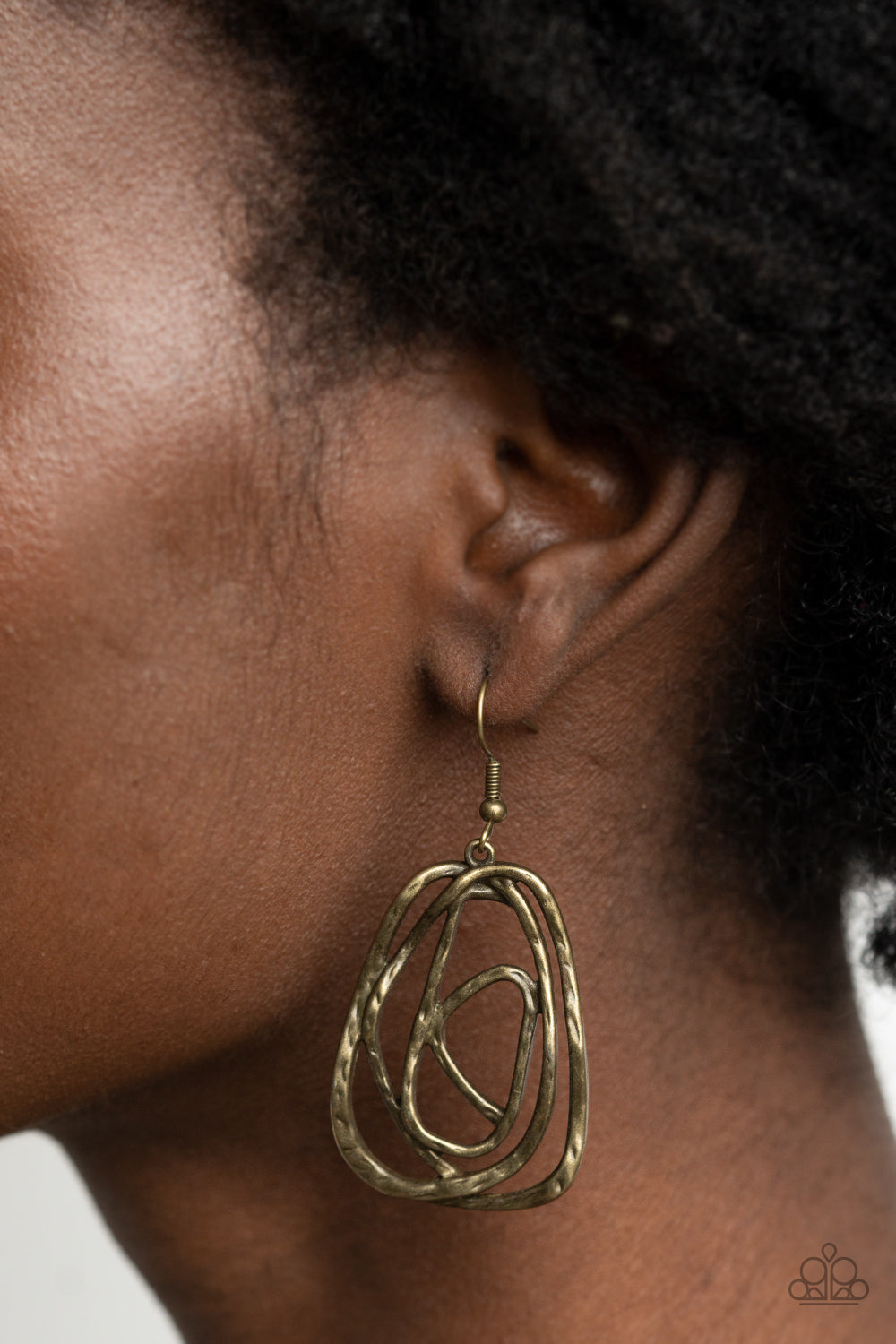 &lt;p&gt;Featuring a hammered finish, a rustic brass wire delicately wraps into an asymmetrical frame for a dizzying artisan inspired look. Earring attaches to a standard fishhook fitting. &lt;/p&gt;  

&lt;p&gt; &lt;i&gt;  Sold as one pair of earrings. &lt;/i&gt;  &lt;/p&gt;


