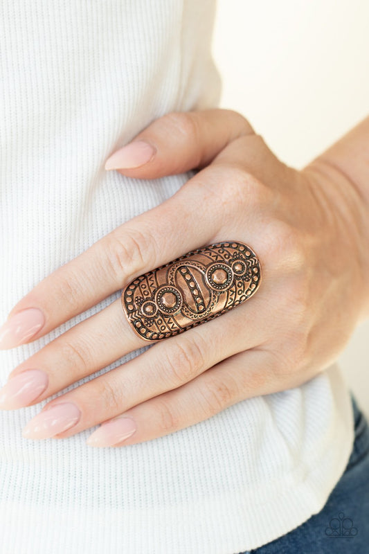 &lt;p&gt; Studded and stamped in tribal inspired textures, an oversized copper frame folds around the finger for a rustically authentic look. Features a stretchy band for a flexible fit.&lt;/p&gt;  
 

 &lt;p&gt; &lt;i&gt; Sold as one individual ring.
 &lt;/i&gt;&lt;/p&gt;
 

&lt;h5&gt;Paparazzi Accessories • $5 Jewelry&lt;/h5&gt;