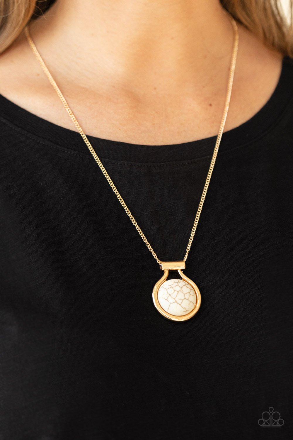 &lt;p&gt;Encased in an artisan inspired gold fitting, a refreshing white stone pendant glides along a gold chain for a colorfully seasonal look. Features an adjustable clasp closure.
 &lt;/p&gt;

&lt;p&gt;&lt;i&gt; Sold as one individual necklace.  Includes one pair of matching earrings&lt;/i&gt;&lt;/p&gt;