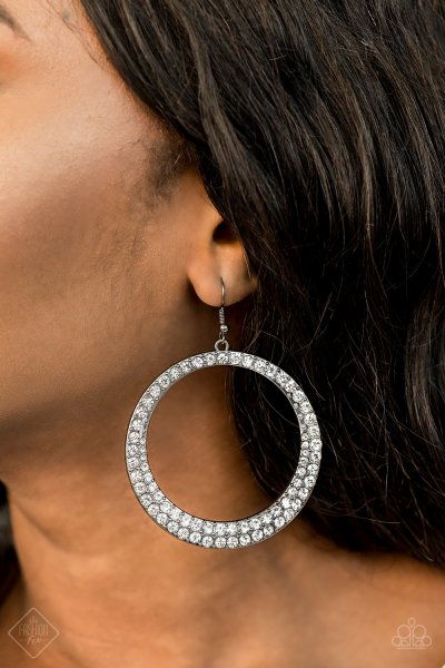 An oversized gunmetal hoop is encrusted in glittery white rhinestones resulting in a blinding Shimmer that refuses to be ignored.&amp;nbsp; Earring attached to a standard fishhook fitting.&amp;nbsp;