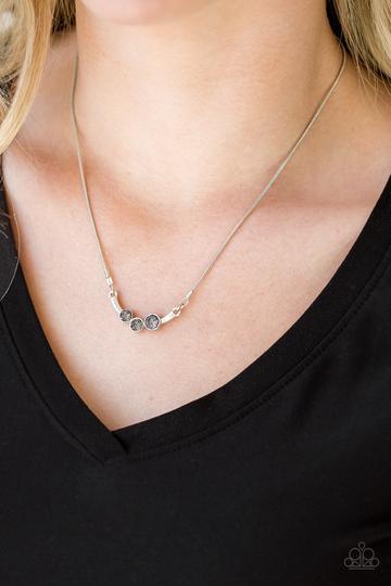 &lt;p&gt;A trio of smoky rhinestones are encrusted along a bowing silver bar, creating a stellar pendant below the collar. Features an adjustable clasp closure.&lt;/p&gt;
&lt;p&gt;&lt;em&gt;Sold as one individual necklace. Includes one pair of matching earrings.&lt;/em&gt;&lt;/p&gt;