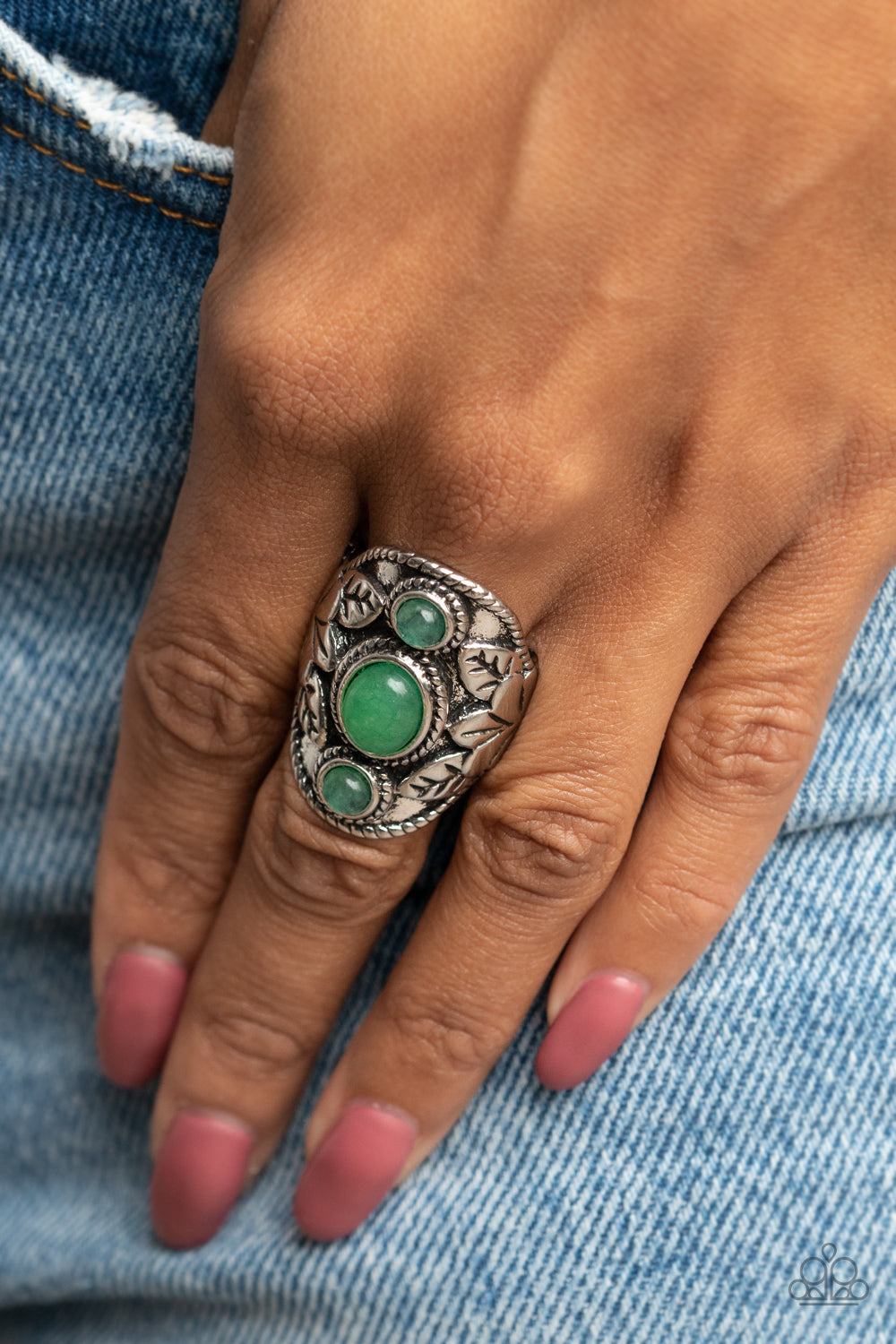 Embossed in whimsical palm leaf patterns, a rustic silver frame is dotted in three jade stones for a mystical finish. Features a stretchy band for a flexible fit. Sold as one individual ring.&amp;nbsp;
