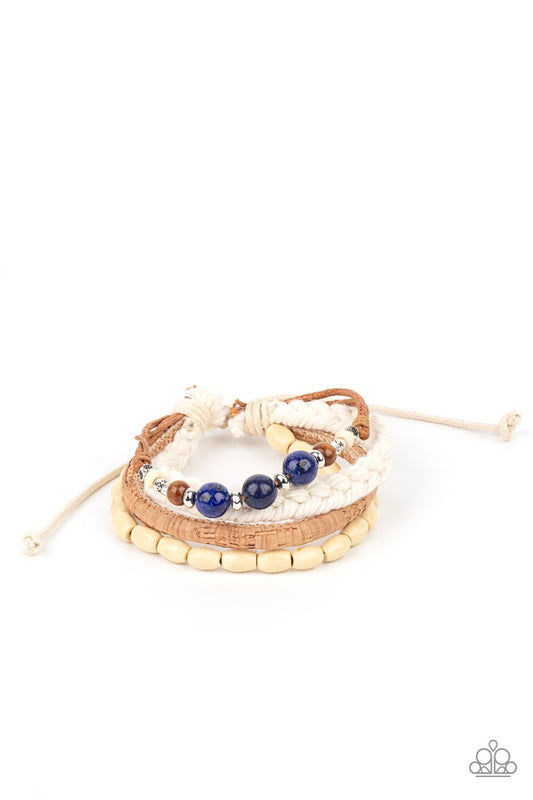&lt;p&gt;Featuring cork, thread, and wood, mismatched metallic accents, glassy blue stones, and wood beads adorn earthy layers around the wrist for a whimsical look. Features an adjustable sliding knot closure.&lt;/p&gt;
&lt;p&gt;&lt;i&gt;Sold as one individual bracelet.&lt;/i&gt;&lt;/p&gt;