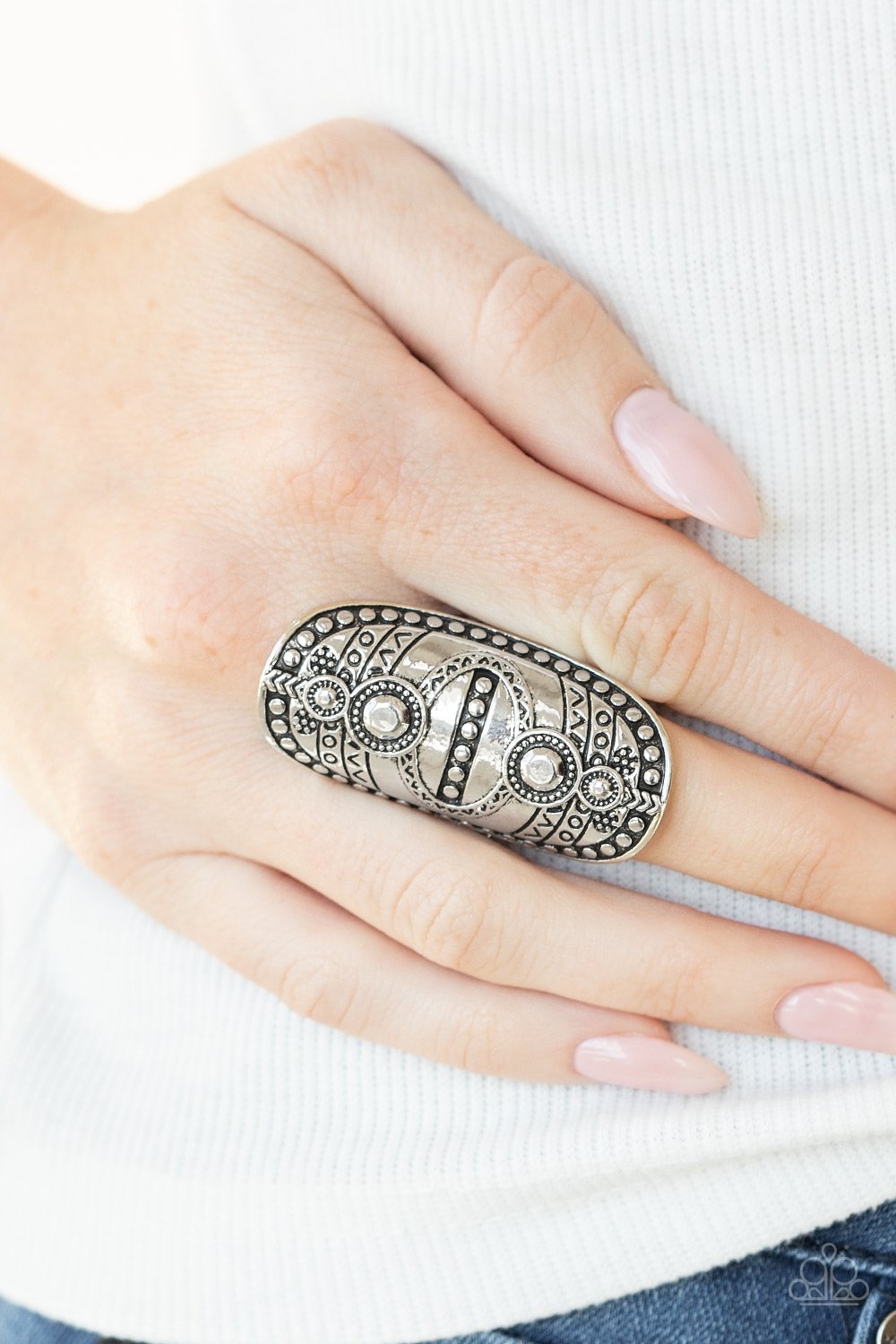 &lt;p&gt; Studded and stamped in tribal inspired textures, an oversized silver frame folds around the finger for a rustically authentic look. Features a stretchy band for a flexible fit.&lt;/p&gt;  
 

 &lt;p&gt; &lt;i&gt; Sold as one individual ring.
 &lt;/i&gt;&lt;/p&gt;
 

&lt;h5&gt;Paparazzi Accessories • $5 Jewelry&lt;/h5&gt;