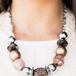Warm beads in shades of brown and copper with reflective faceted edges and varying glazed finishes are offset by two shiny silver beads. An oblong bead studded with copper-toned rhinestones adds a dramatic accent. Features an adjustable clasp closure.